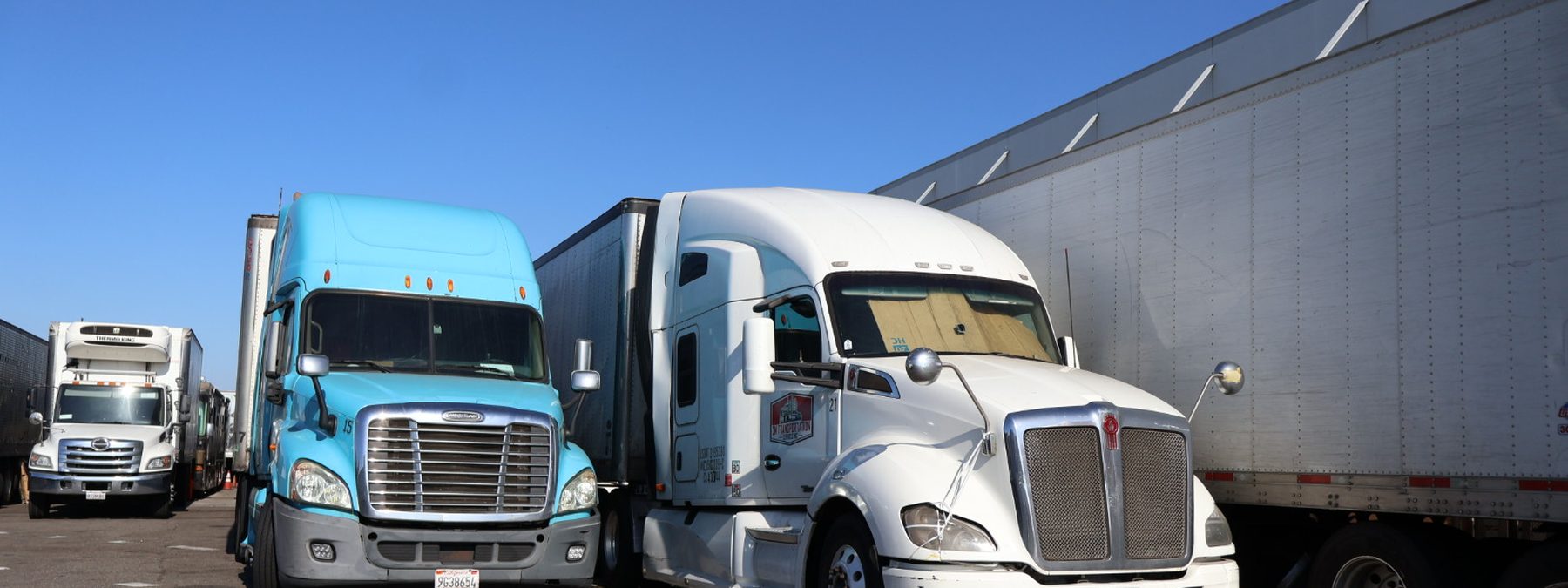 Tractors and refrigerated trailers staged at a California dock